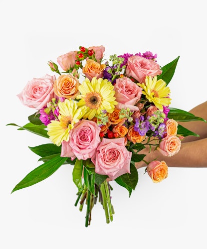 Vibrant floral bouquet featuring pink roses, sunny gerberas, and colorful accents.