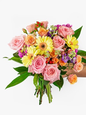 Vibrant floral bouquet featuring pink roses, sunny gerberas, and colorful accents.