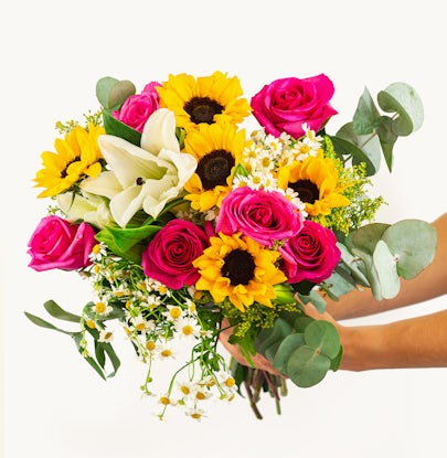 Vibrant bouquet featuring pink roses, sunflowers, and white blooms, ideal for cheerful occasions.