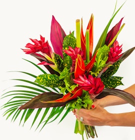 Vibrant tropical bouquet featuring red ginger flowers and lush greenery, ideal for any occasion.