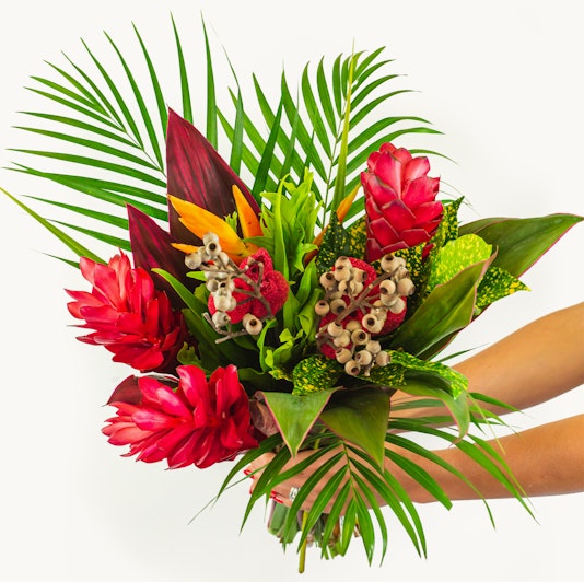 Vibrant tropical flower bouquet featuring red ginger, birds of paradise, and lush greenery.