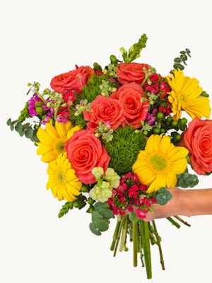 Vibrant bouquet of orange roses, yellow daisies, and lush greenery for cheerful occasions.