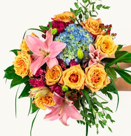 Vibrant floral bouquet featuring lilies, roses, and hydrangeas in cheerful colors.
