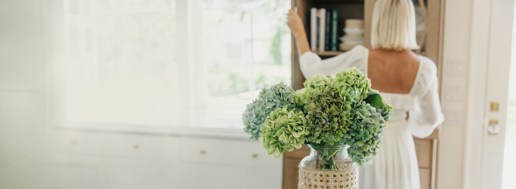 A beautiful vase of green hydrangeas on a table, enhancing a serene indoor atmosphere.