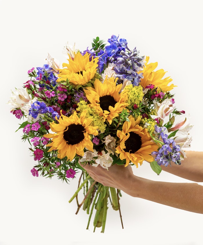 Bright sunflower bouquet featuring purple and pink blooms, perfect for cheerful occasions.