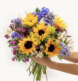 Bright sunflower bouquet featuring purple and pink blooms, perfect for cheerful occasions.