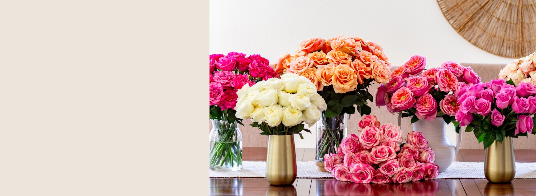 Vibrant floral display featuring pink, orange, and white roses in elegant vases.
